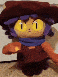 a stuffed animal wearing a cowboy hat and overalls